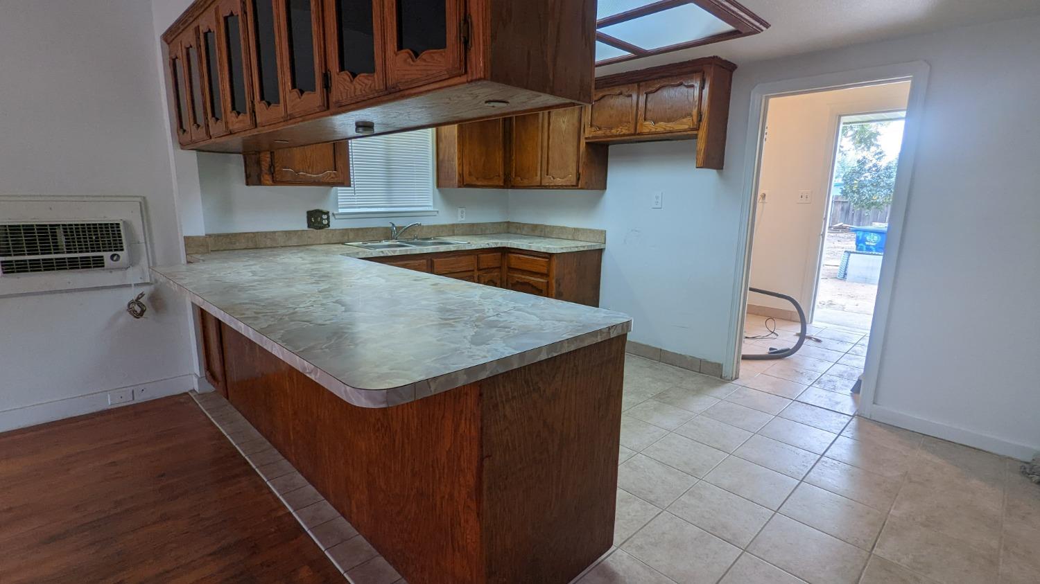 930 Sierra Street Madera, CA 93638 - Photo 5 of 16 a kitchen with a sink a counter top space and cabinets