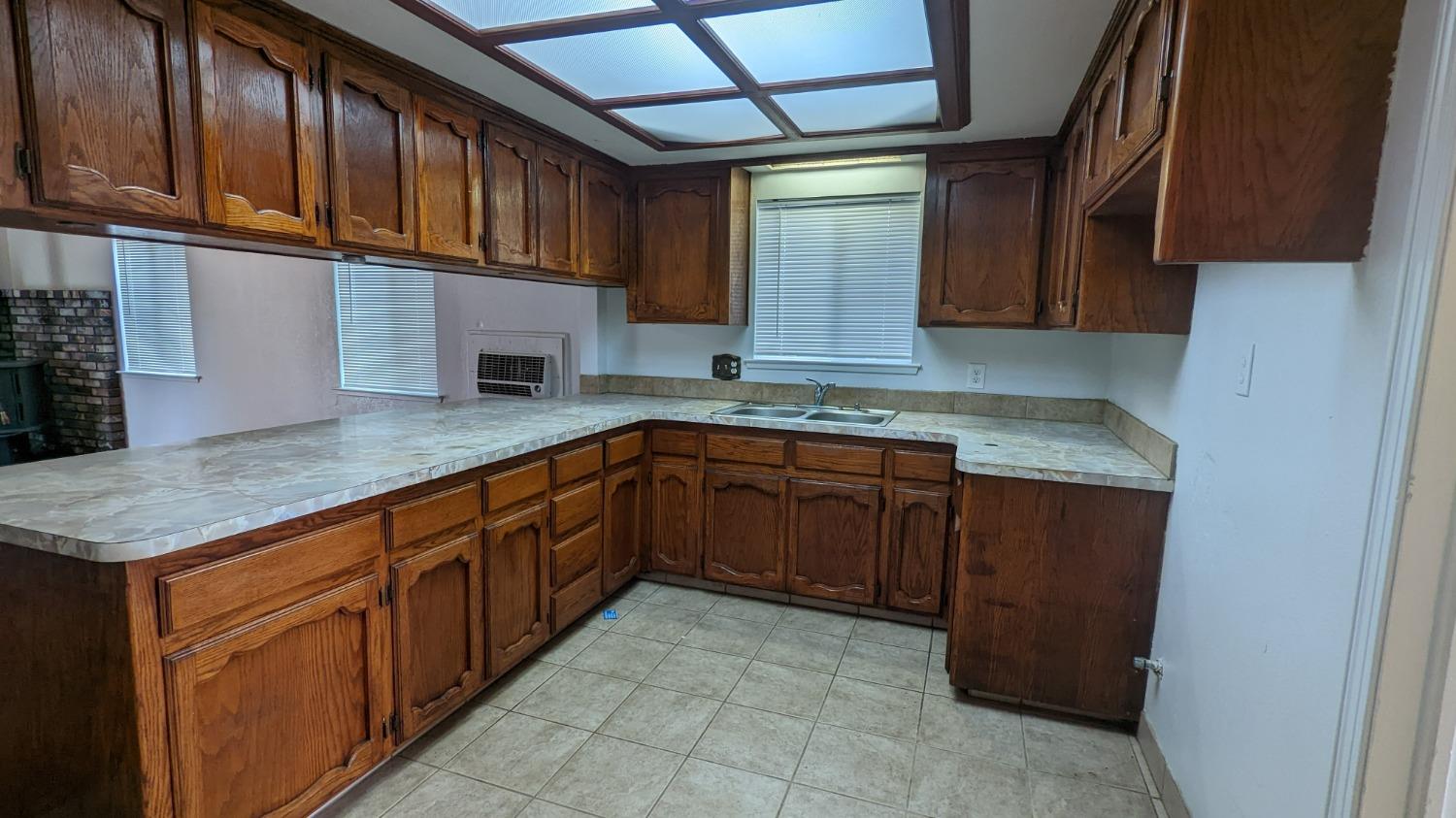 930 Sierra Street Madera, CA 93638 - Photo 6 of 16 a kitchen with stainless steel appliances granite countertop a sink stove and cabinets