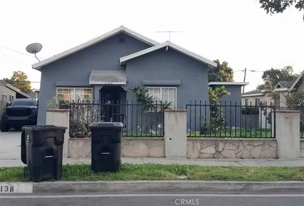 a front view of house yard and car parked