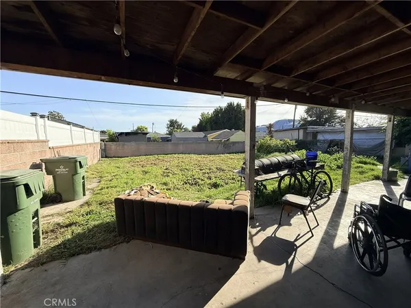 a view of a chairs and table in patio with a yard