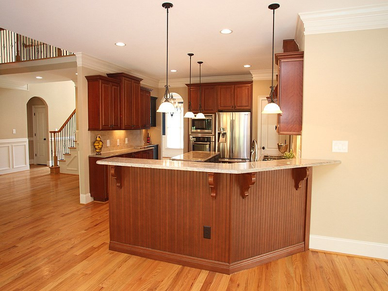 2317 Finley Ridge Lane Raleigh, NC 27615 - Photo 6 of 23 Open Kitchen w/ Custom Soft Close Cabinets and Drawers, Two Toned Island, Gorgeous Granite, Upgraded Appliances and Two Pantrys. Bar opens to Keeping/Hearth Room and Breakfast Area. Kitchen