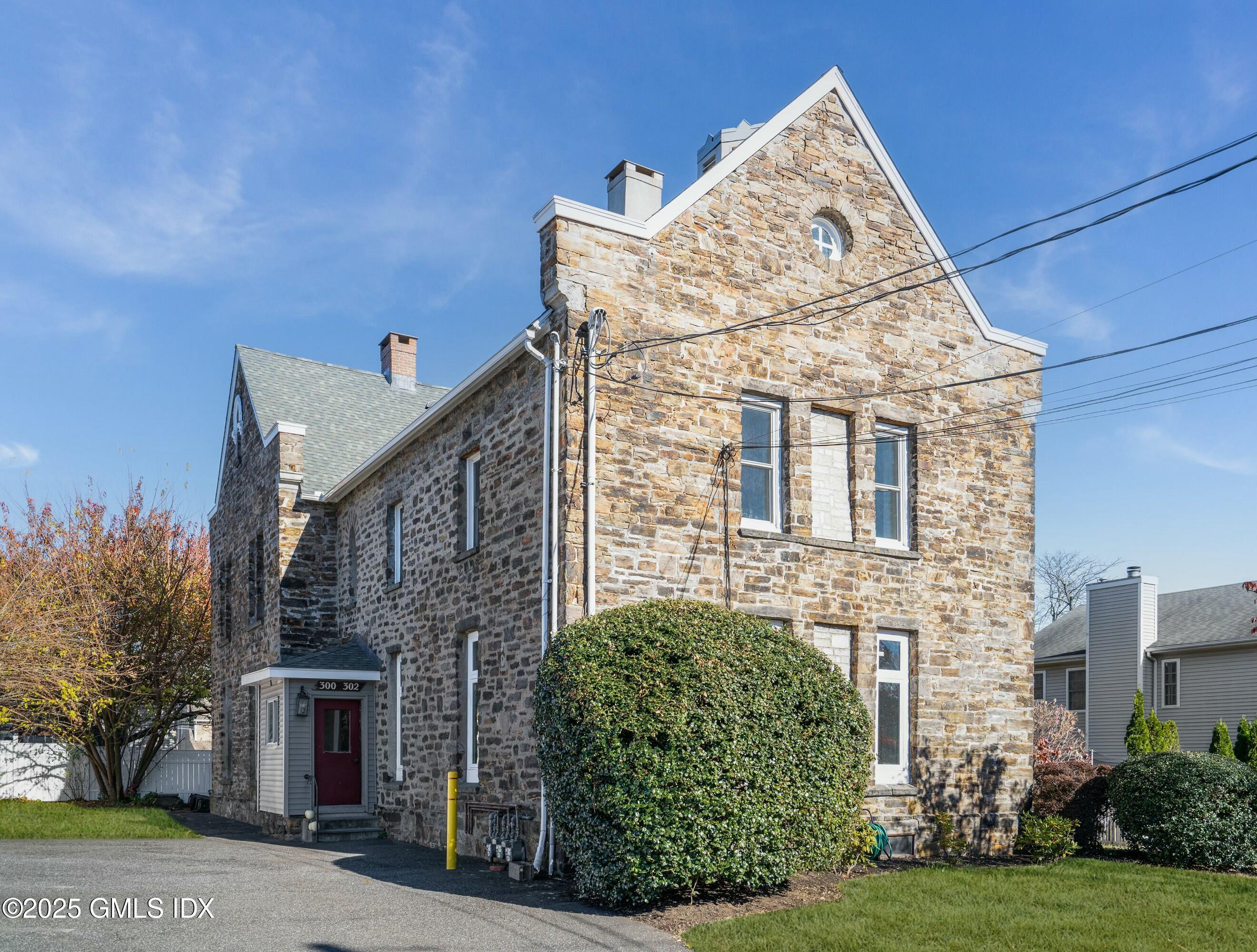 300-302 Soundview Avenue, Unit 2 Fairfield, CT 06825 - Photo 1 of 20 a view of a brick house with a large windows