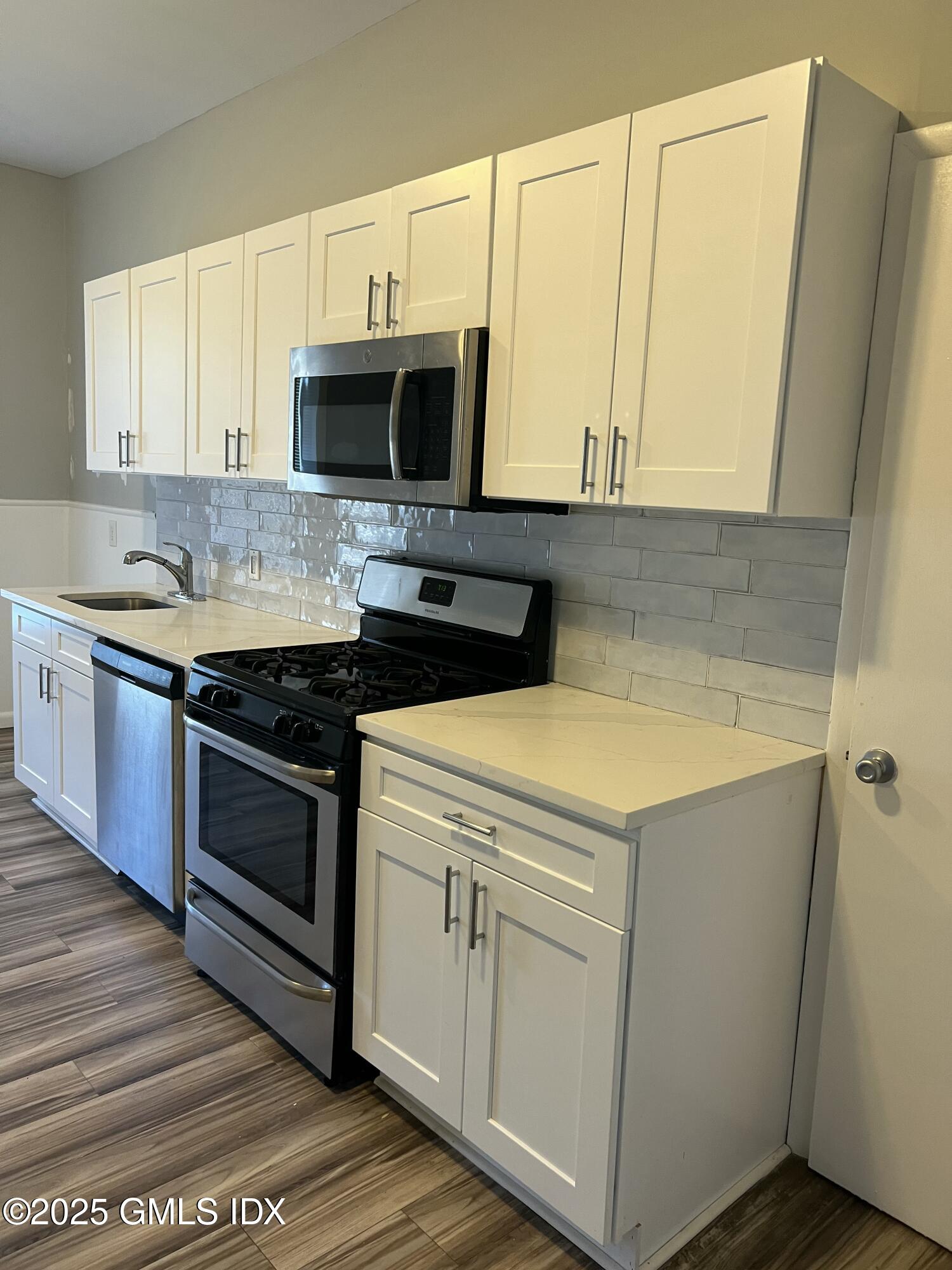 300-302 Soundview Avenue, Unit 2 Fairfield, CT 06825 - Photo 5 of 20 a kitchen with stainless steel appliances a stove microwave and sink