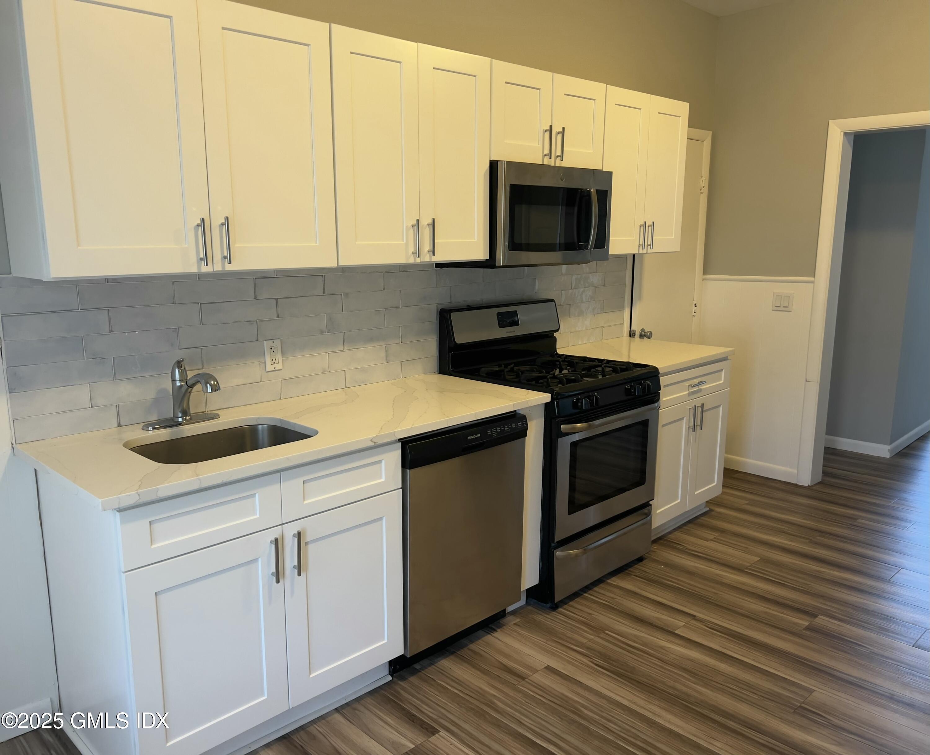 300-302 Soundview Avenue, Unit 2 Fairfield, CT 06825 - Photo 7 of 20 a kitchen with a sink stove and microwave