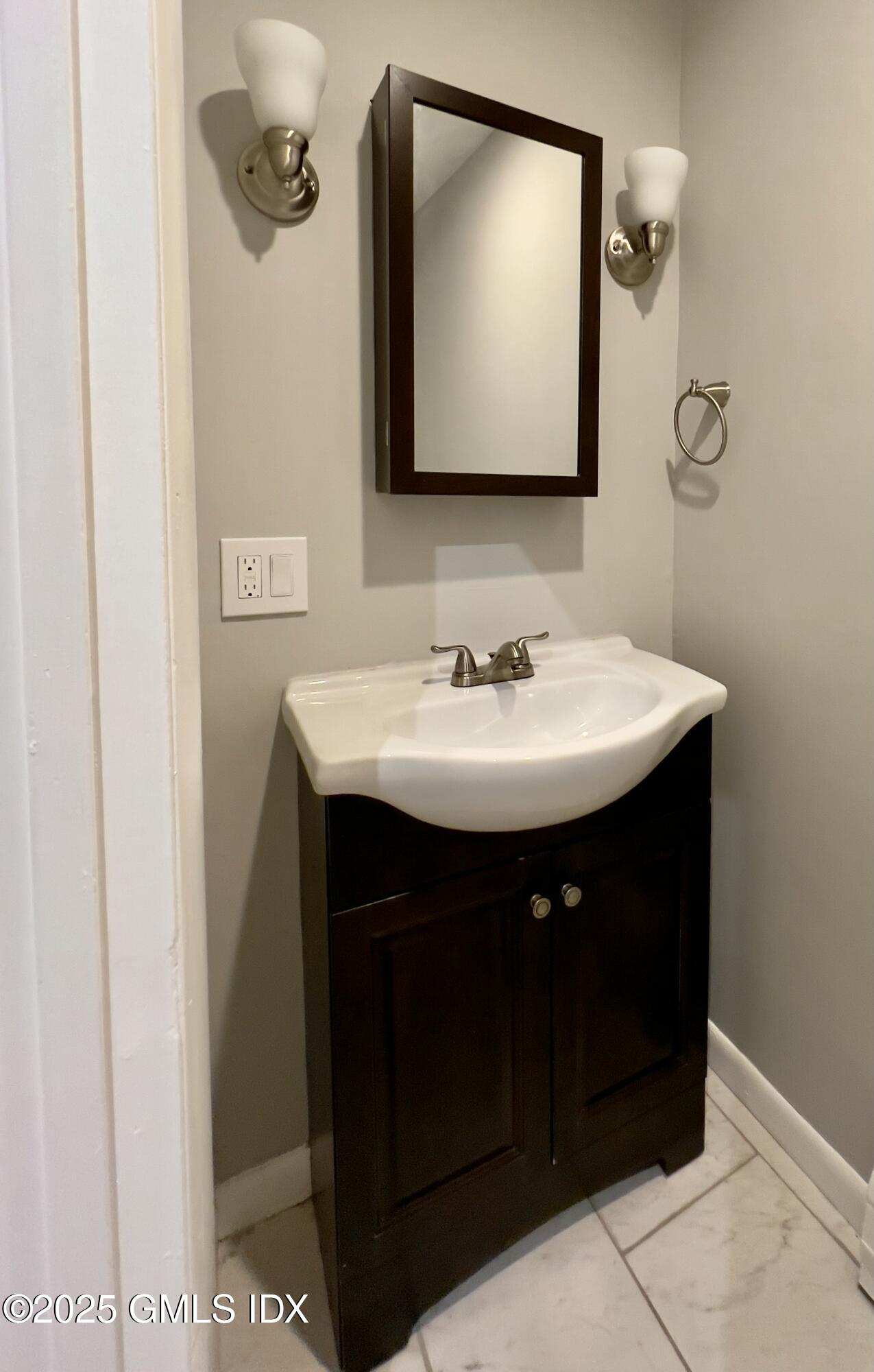 300-302 Soundview Avenue, Unit 2 Fairfield, CT 06825 - Photo 10 of 20 a bathroom with a sink and a mirror