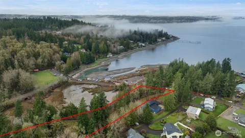 a view of a lake with a yard and mountain view in back