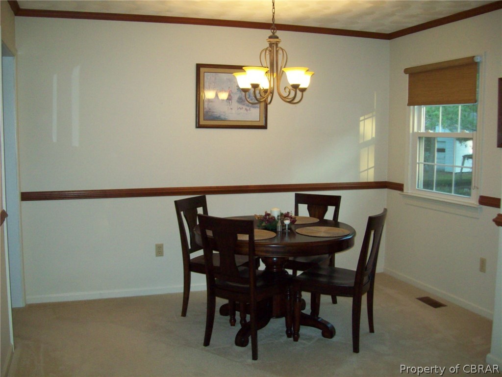 195 Hurst Neck Road Onemo, VA 23130 - Photo 15 of 30 a view of a dining room with furniture and chandelier