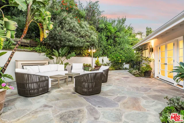 a bathroom with a granite countertop sink and large mirror