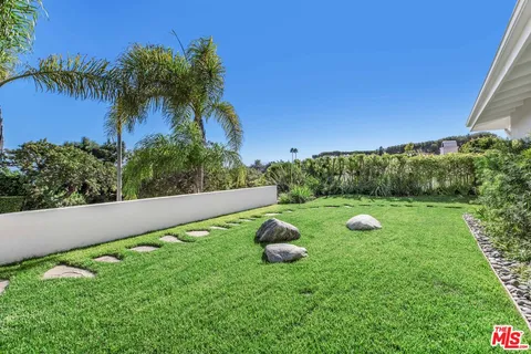 a view of a patio with table and chairs with wooden fence