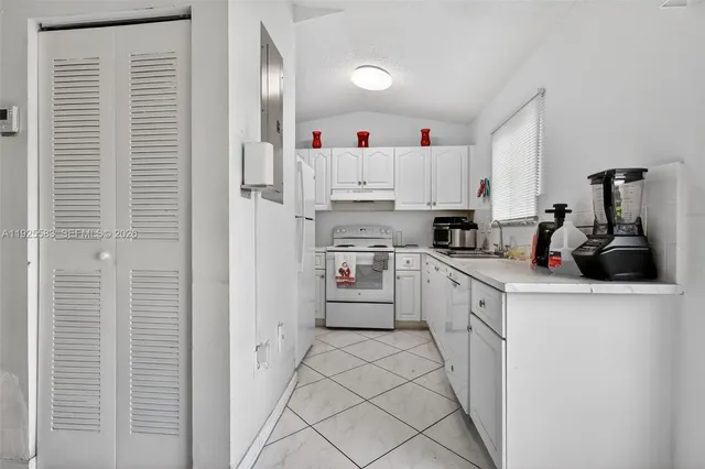 a kitchen with cabinets and white appliances