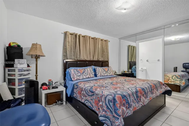 a bedroom with a bed and a dresser in it