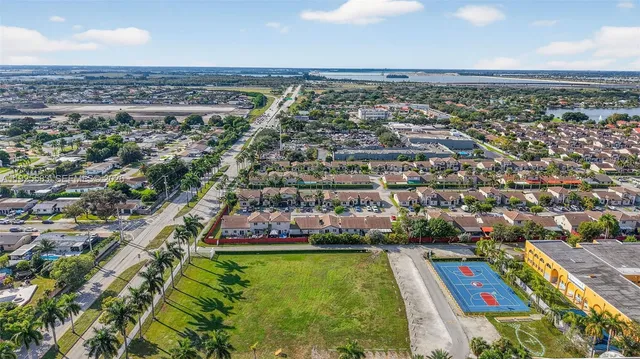 an aerial view of residential houses with yard