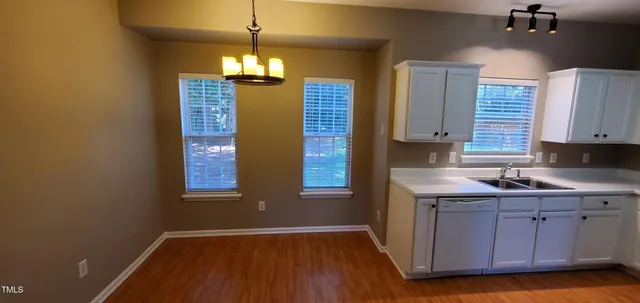 a kitchen with a sink window and cabinets