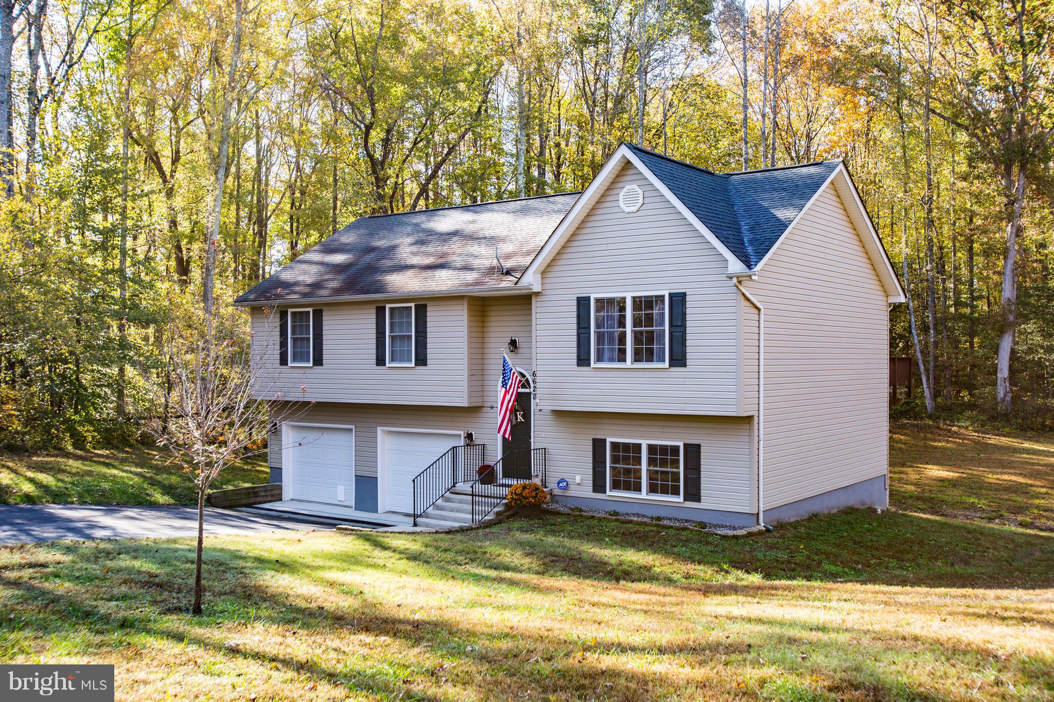 6628 Partlow Road Spotsylvania, VA 22551 - Photo 2 of 22 a view of a house with a small yard plants and large tree