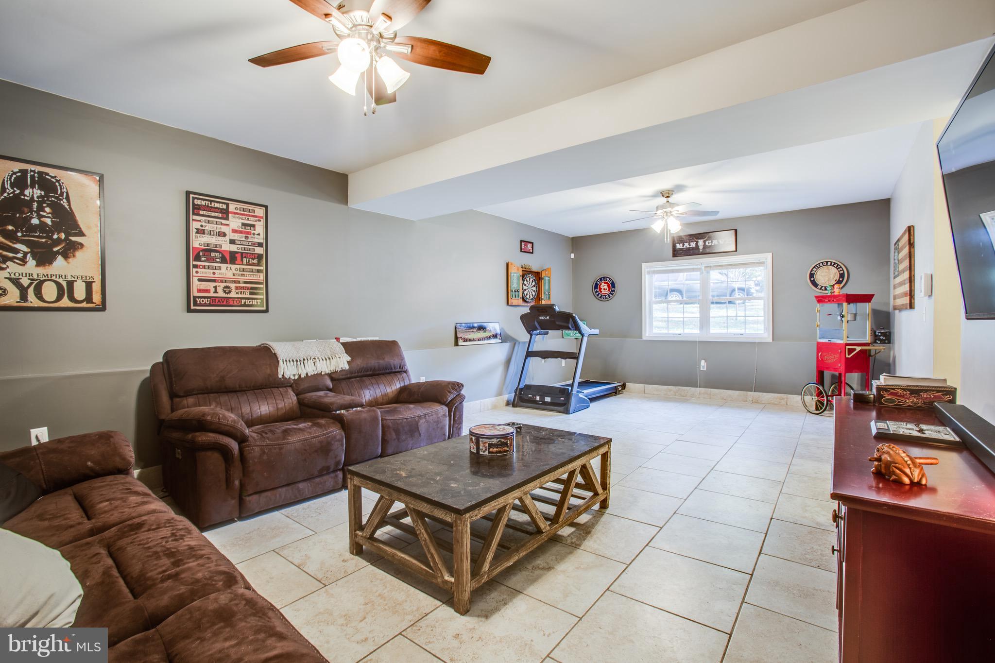 6628 Partlow Road Spotsylvania, VA 22551 - Photo 12 of 22 a living room with furniture a chandelier and a window