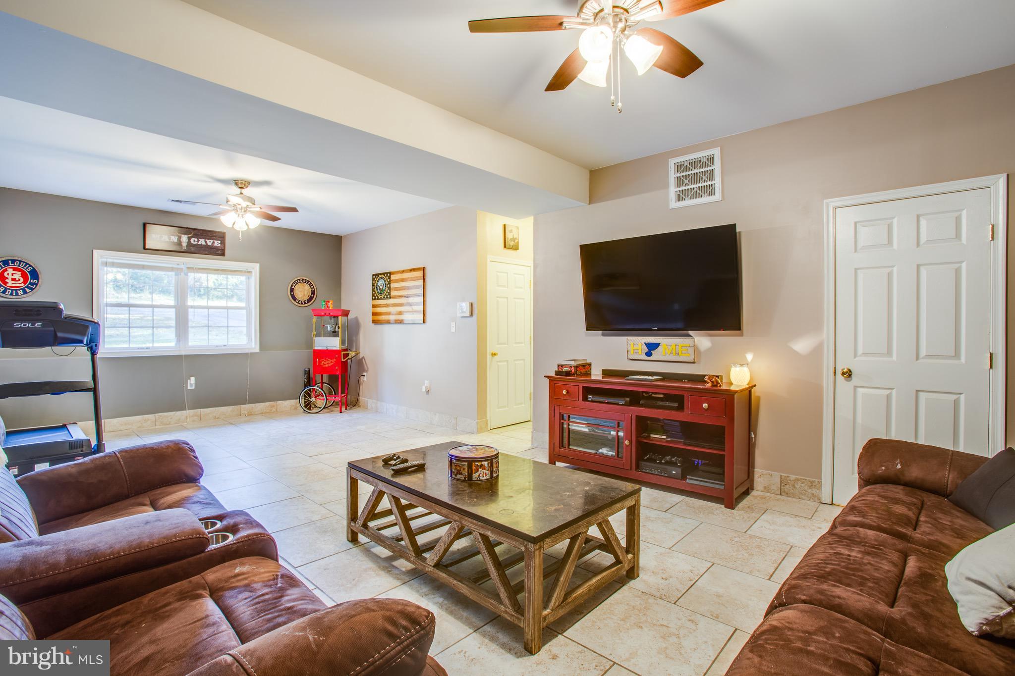 6628 Partlow Road Spotsylvania, VA 22551 - Photo 13 of 22 a living room with furniture and a flat screen tv