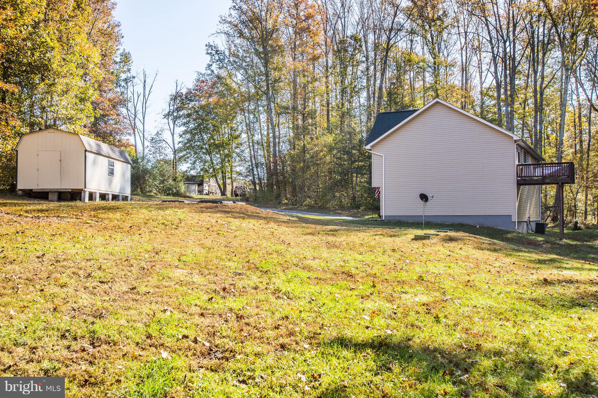 6628 Partlow Road Spotsylvania, VA 22551 - Photo 18 of 22 a house with trees in front of it