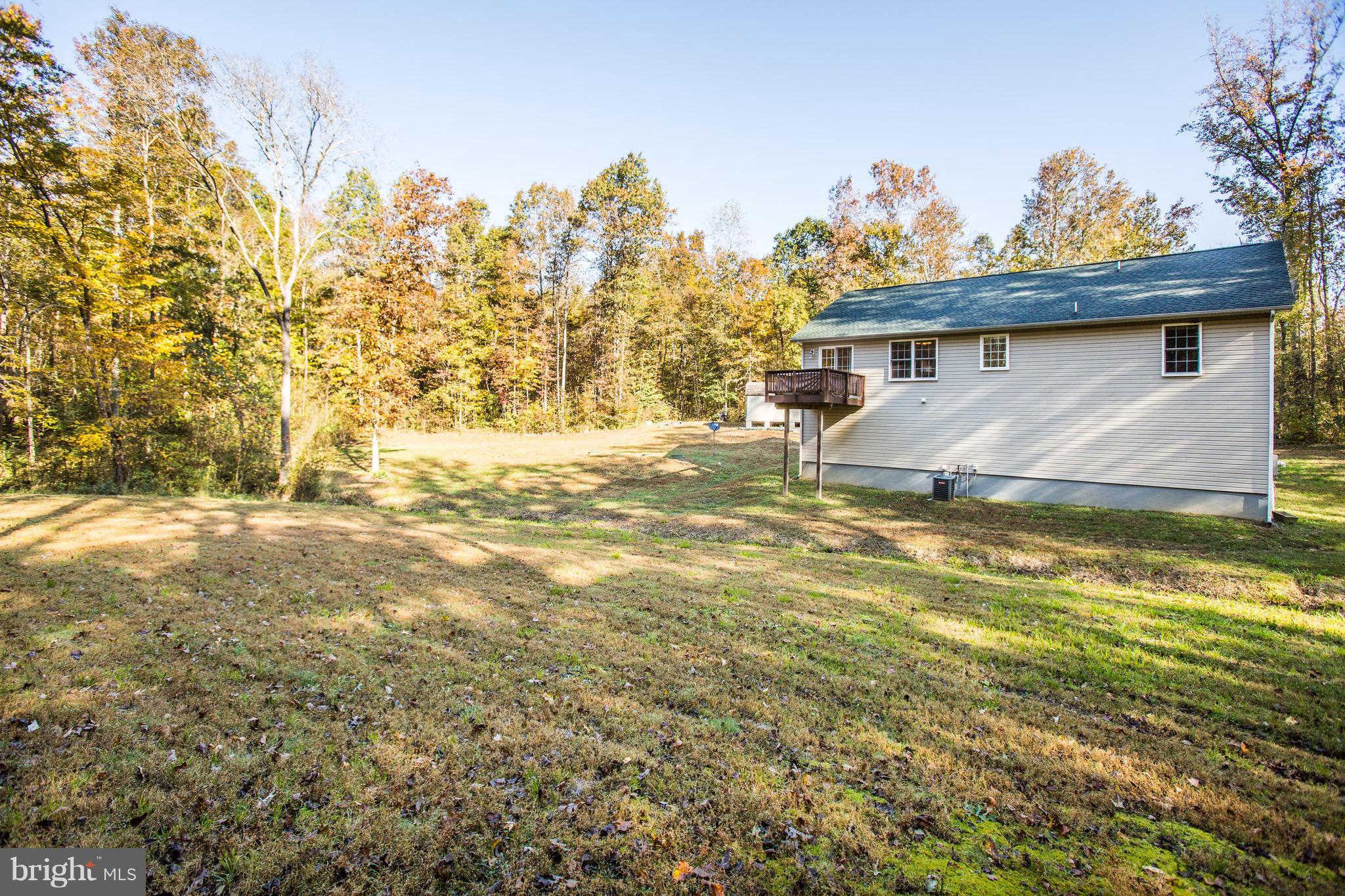 6628 Partlow Road Spotsylvania, VA 22551 - Photo 19 of 22 a view of a house with a yard and sitting area