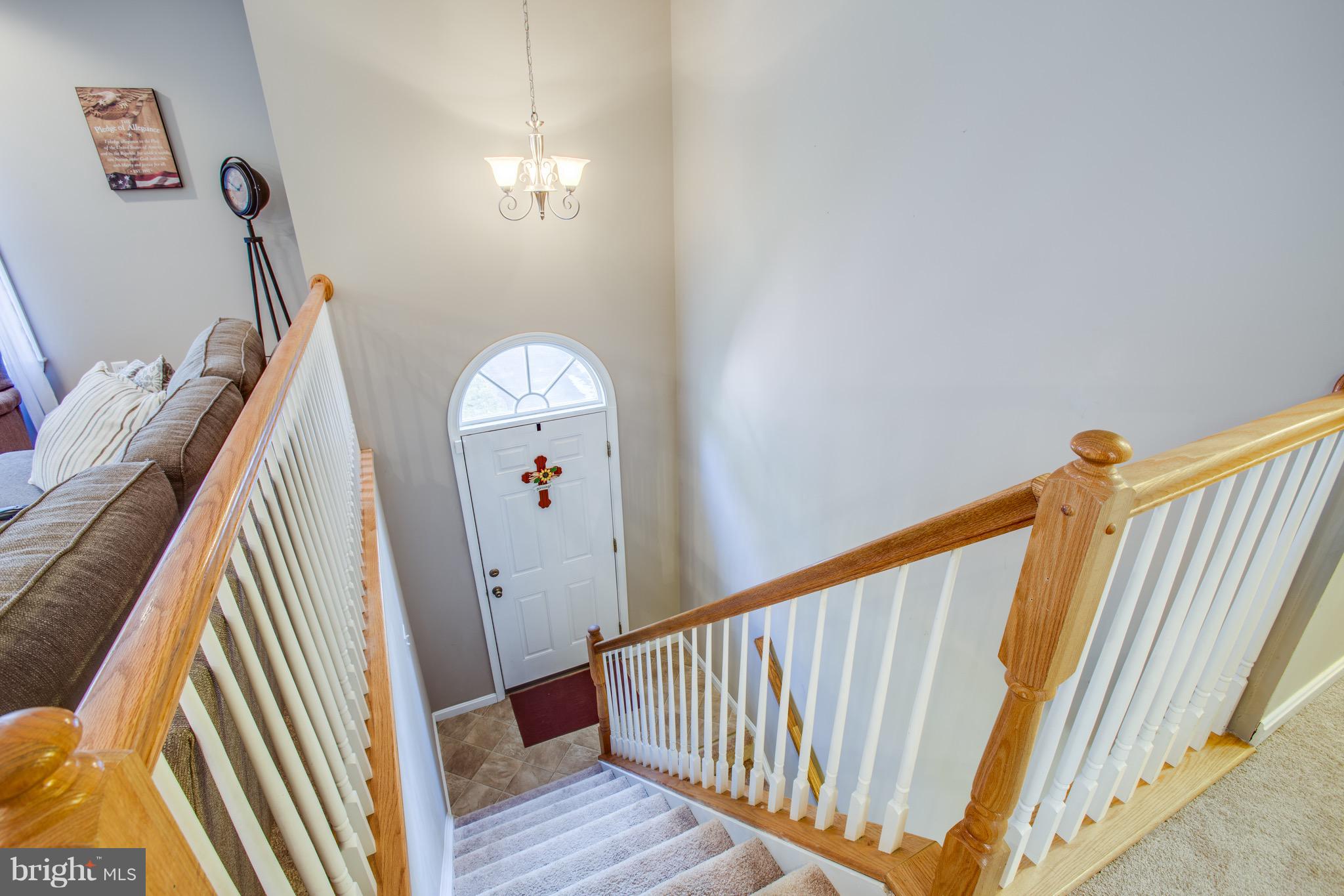 6628 Partlow Road Spotsylvania, VA 22551 - Photo 4 of 22 a view of a livingroom with wooden floor and stairs