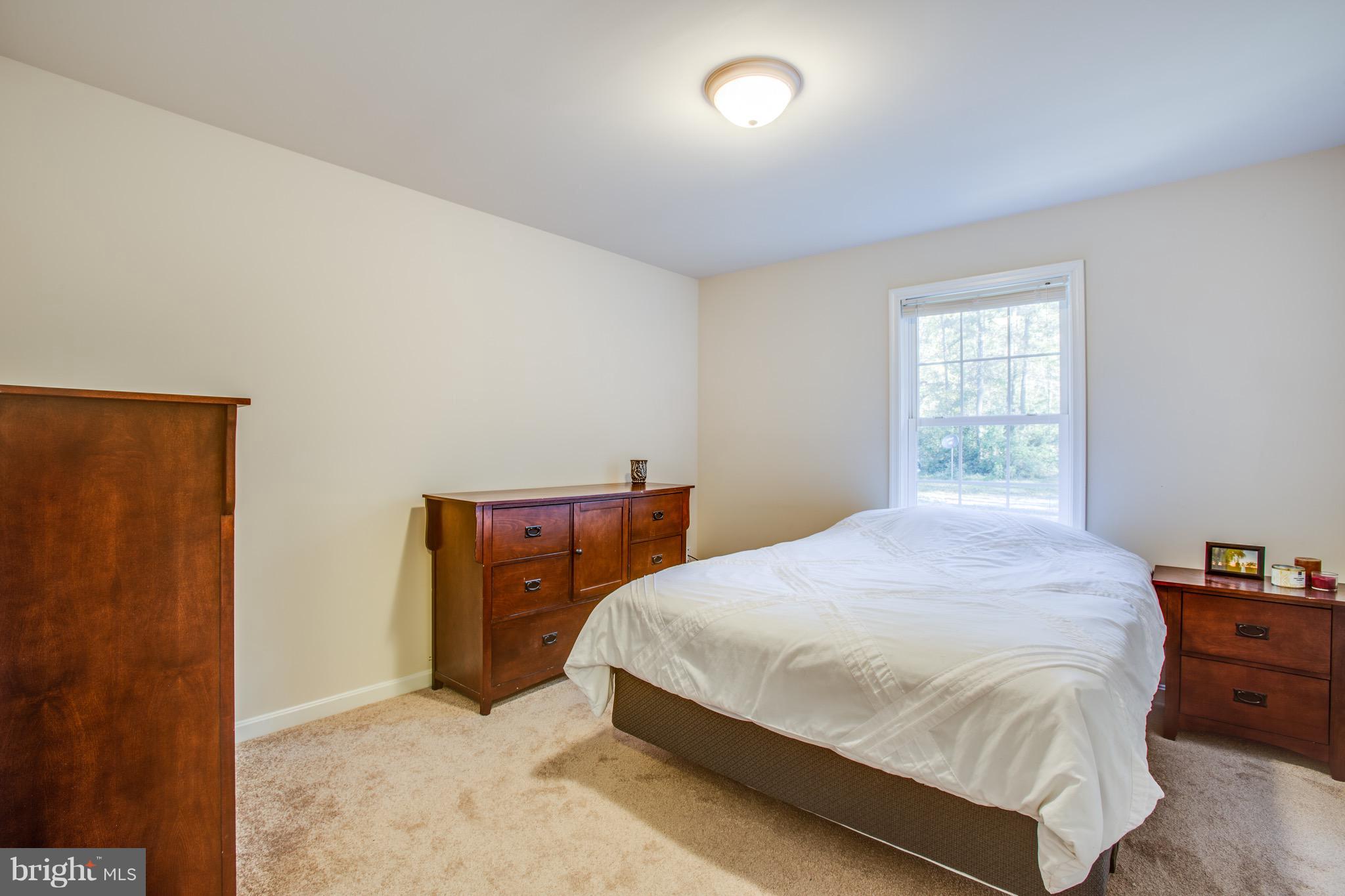 6628 Partlow Road Spotsylvania, VA 22551 - Photo 8 of 22 a bedroom with a bed and window