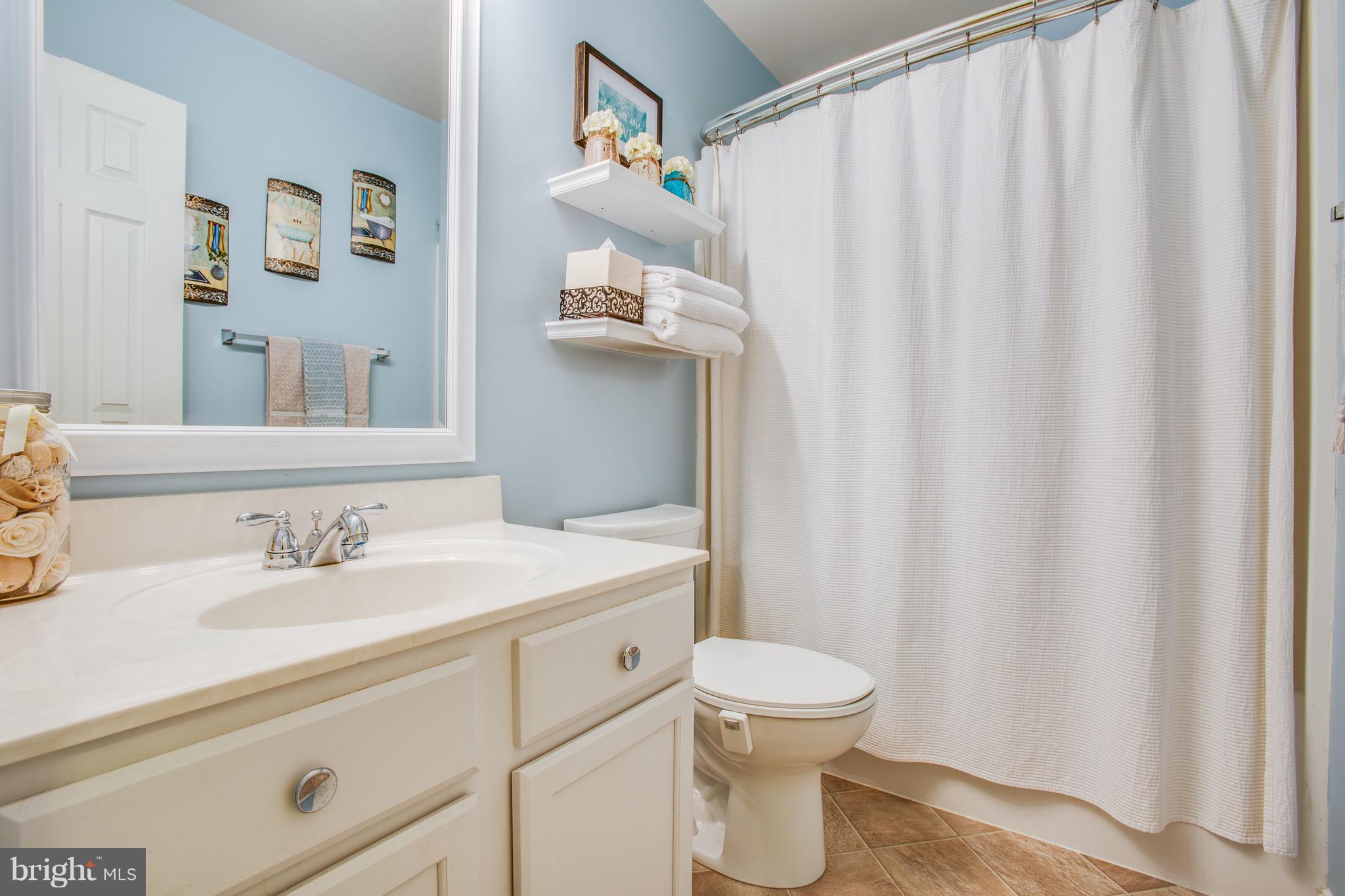 6628 Partlow Road Spotsylvania, VA 22551 - Photo 10 of 22 a bathroom with a sink and a mirror