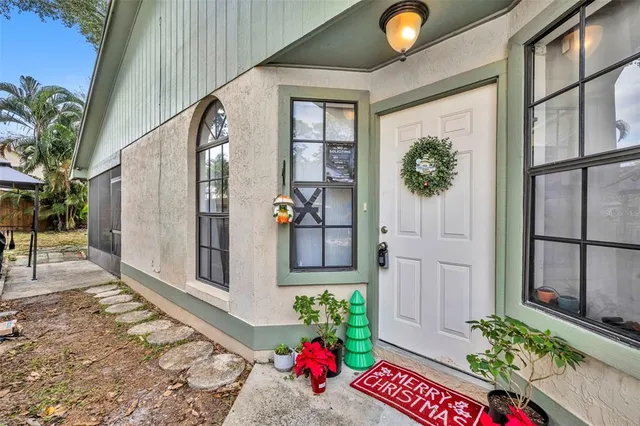 a living room with furniture a chandelier and kitchen view