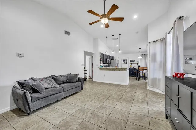 a large kitchen with stainless steel appliances lots of counter space and windows