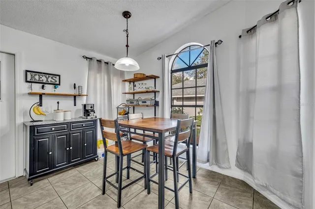 a view of a kitchen and a dining table with chairs