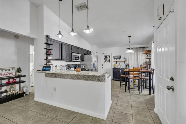 a large kitchen with lots of counter and living room