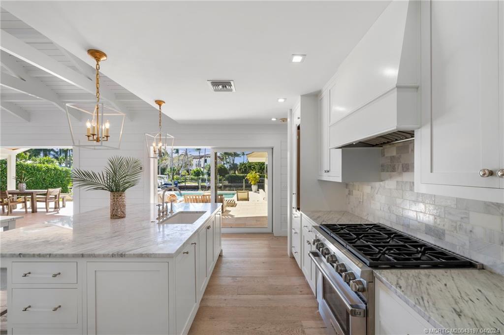 19 River Drive Jupiter, FL 33469 - Photo 13 of 46 a kitchen with granite countertop a stove and a sink