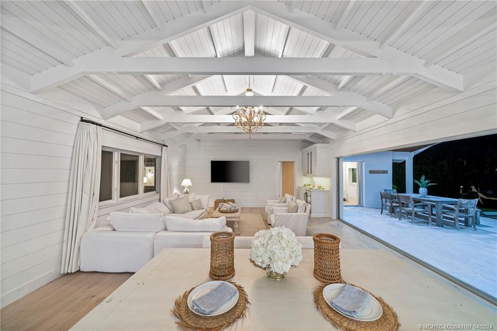 19 River Drive Jupiter, FL 33469 - Photo 15 of 46 a living room with furniture a flat screen tv and kitchen view