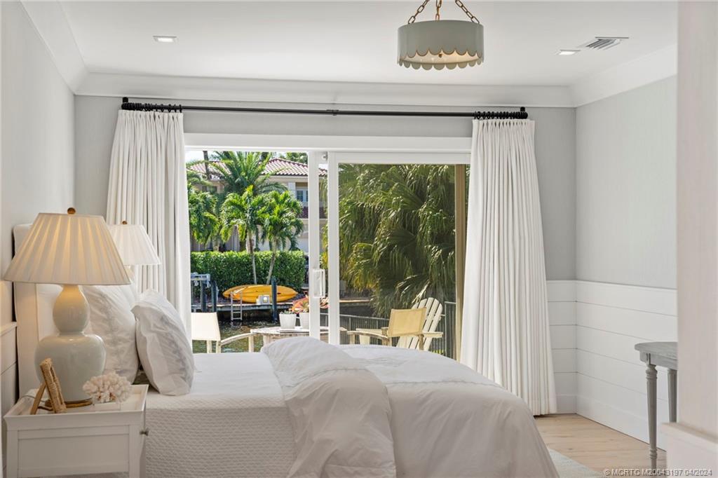 19 River Drive Jupiter, FL 33469 - Photo 20 of 46 a bedroom with furniture and a large window