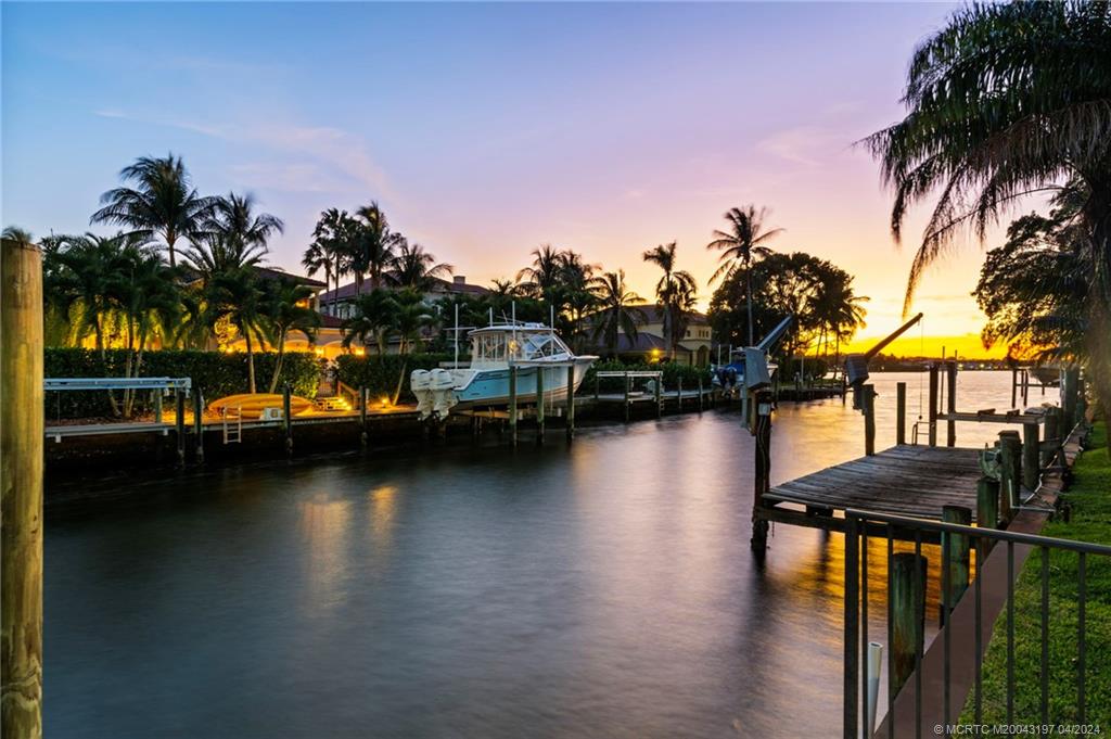 19 River Drive Jupiter, FL 33469 - Photo 2 of 46 a view of a lake with boats and palm trees