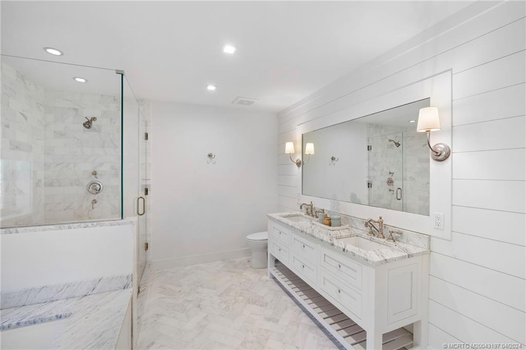 19 River Drive Jupiter, FL 33469 - Photo 22 of 46 a bathroom with a double vanity sink mirror and shower