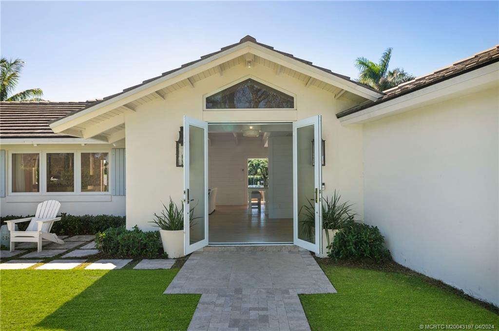 19 River Drive Jupiter, FL 33469 - Photo 26 of 46 a front view of a house with a yard