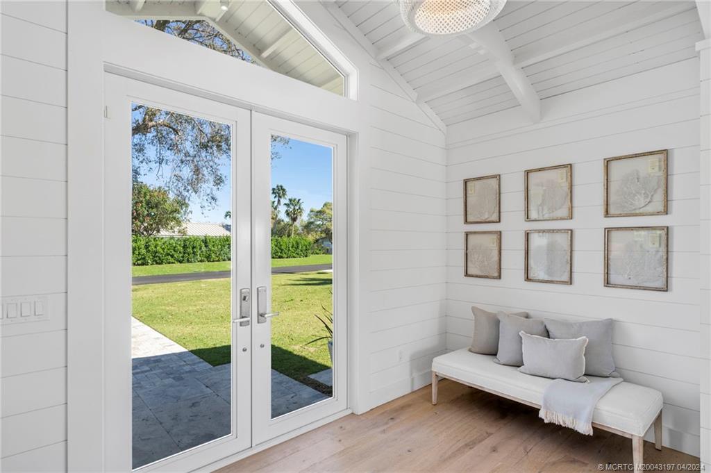 19 River Drive Jupiter, FL 33469 - Photo 27 of 46 a living room with patio furniture and a garden