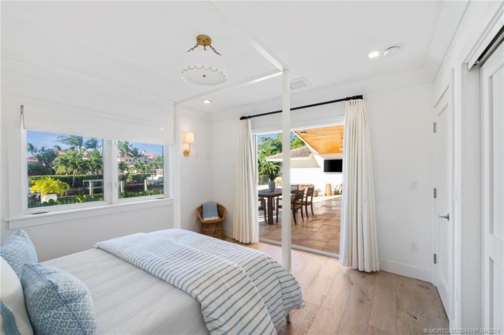 19 River Drive Jupiter, FL 33469 - Photo 34 of 46 a bedroom with a bed and a large window