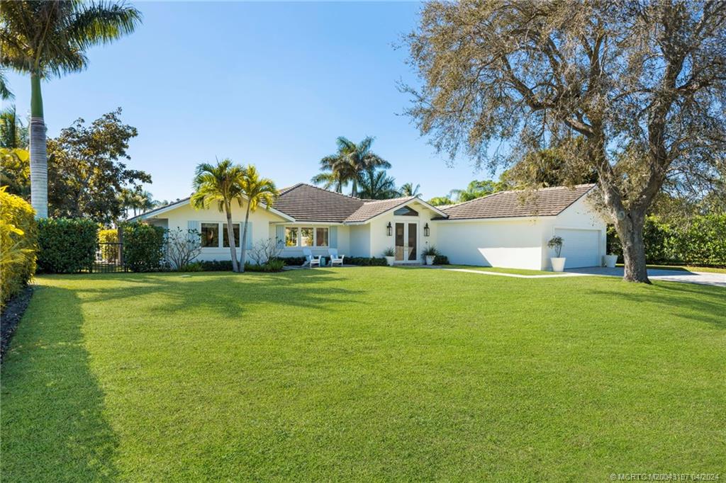 19 River Drive Jupiter, FL 33469 - Photo 6 of 46 a front view of house with yard and seating area