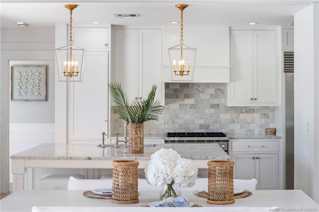 19 River Drive Jupiter, FL 33469 - Photo 9 of 46 a kitchen with a refrigerator and cabinets