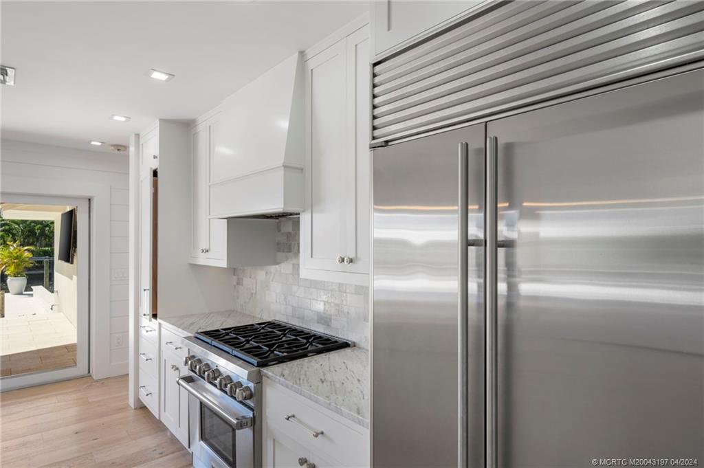 19 River Drive Jupiter, FL 33469 - Photo 10 of 46 a kitchen with stainless steel appliances granite countertop a refrigerator and a stove