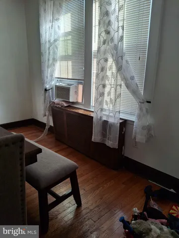 a room with wooden floor and furniture