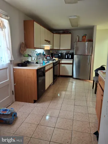 a kitchen with stainless steel appliances granite countertop a refrigerator sink and cabinets
