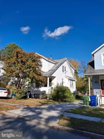a view of a white house with a yard
