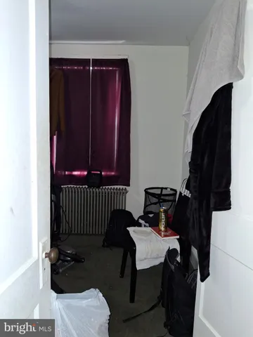 a view of a closet with wooden floor