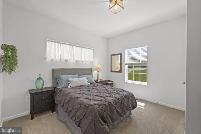 a bed sitting in a bedroom next to a window