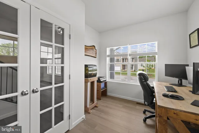 a view of a workspace with furniture and a window