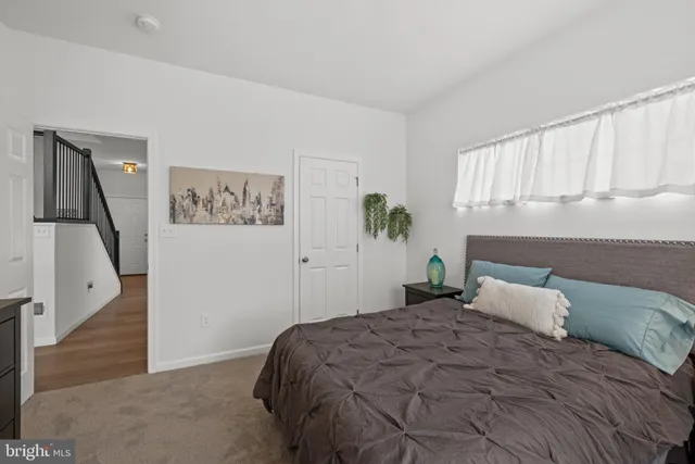 a bedroom with a large bed and a window