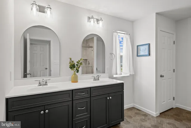 a bathroom with 2 sink and a mirror