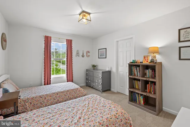 a bedroom with a bed and a bookshelf