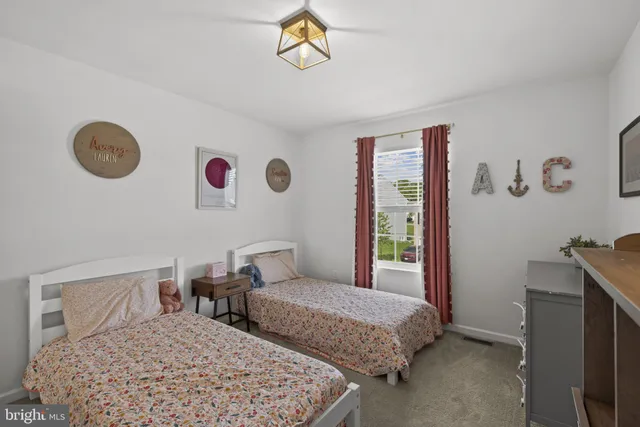 a bedroom with two beds and a window